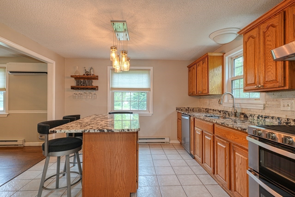 3 Alcorn Road Chelmsford, MA 01824 - Photo 4 of 39 a kitchen with granite countertop a sink stove and cabinets