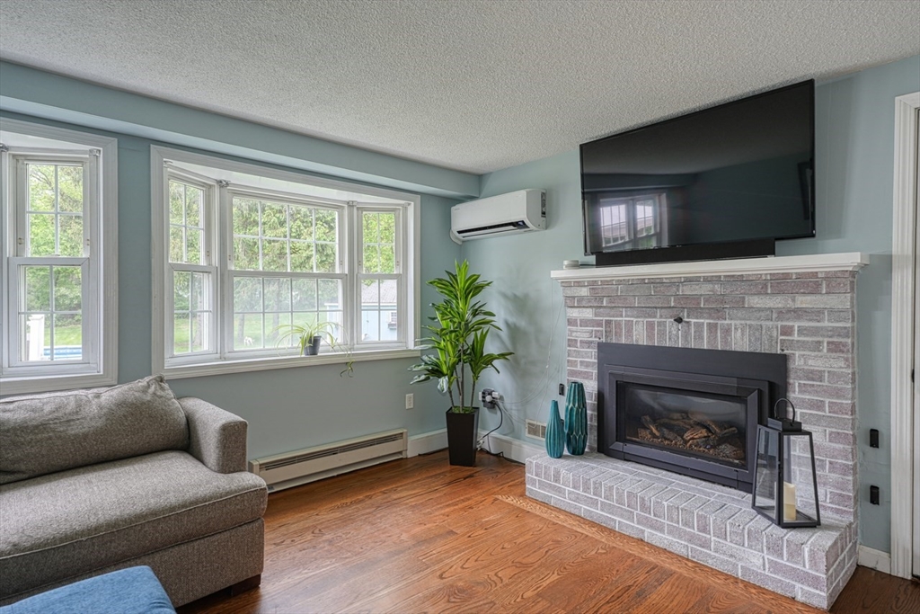 3 Alcorn Road Chelmsford, MA 01824 - Photo 8 of 39 a living room with furniture and a fireplace