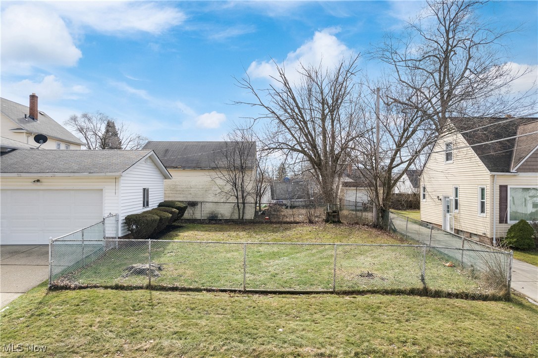447 Center Road Bedford, OH 44146 - Photo 29 of 33 View of yard featuring driveway and fence private yard
