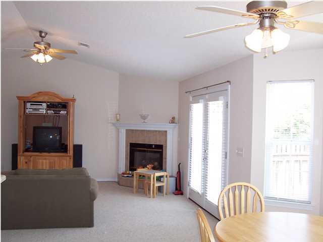 724 Riva Ridge Drive Crestview, FL 32539 - Photo 4 of 4 a living room with furniture a chandelier and a fireplace