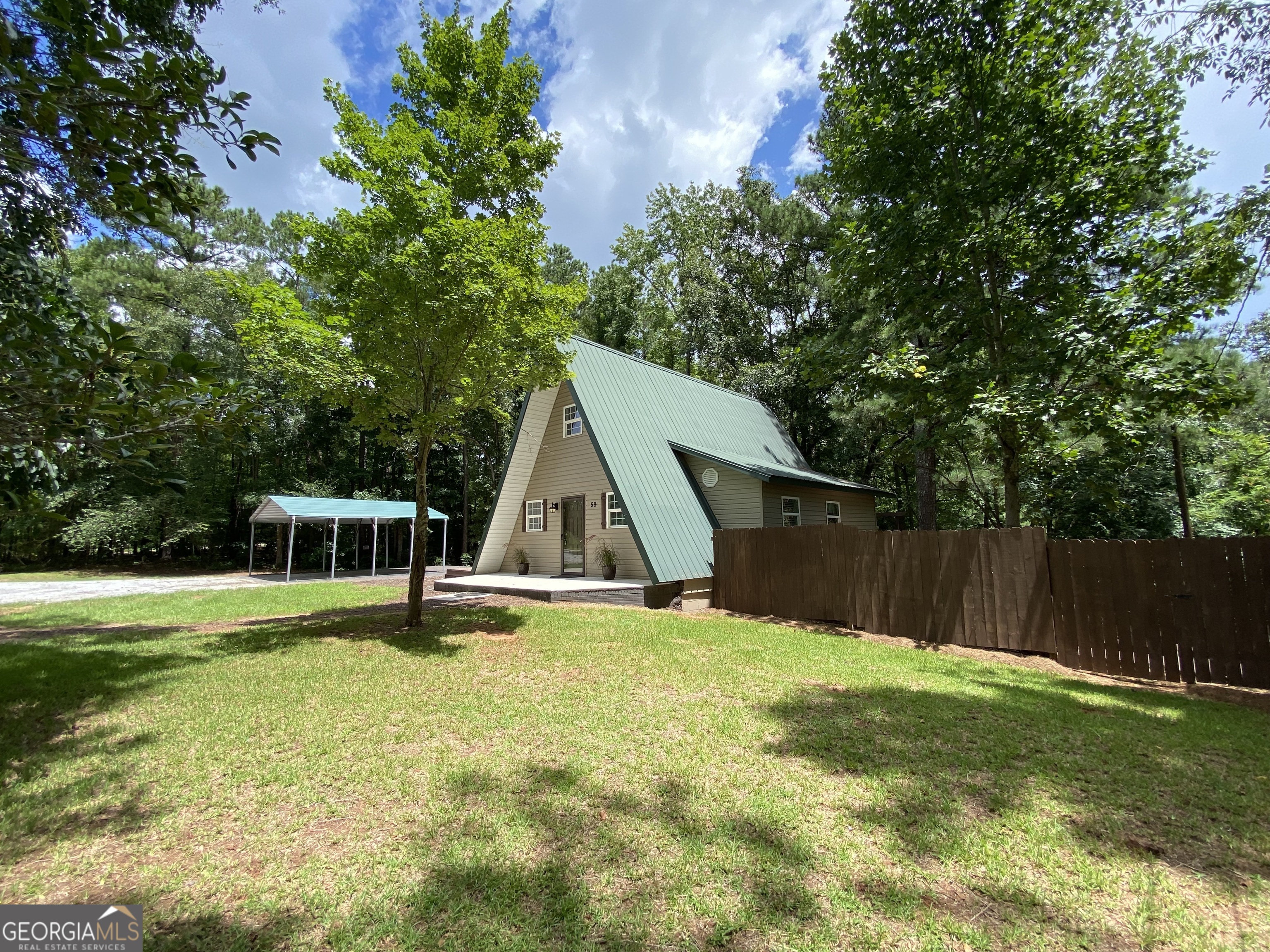 59 Banks Street Thomaston, GA 30286 - Photo 1 of 1 a view of a house with a yard and sitting area