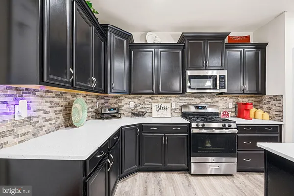 a kitchen with stainless steel appliances a sink stove and refrigerator