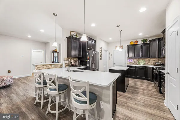 a large kitchen with a table and chairs