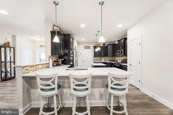 a large kitchen with a table and chairs