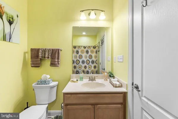 a bathroom with a sink and mirror with toilet
