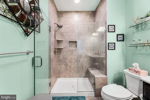 a bathroom with a toilet and a shower