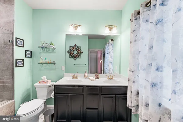 a bathroom with a sink mirror vanity and toilet