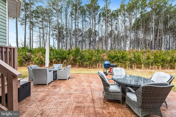 a view of a patio with swimming pool and sitting area