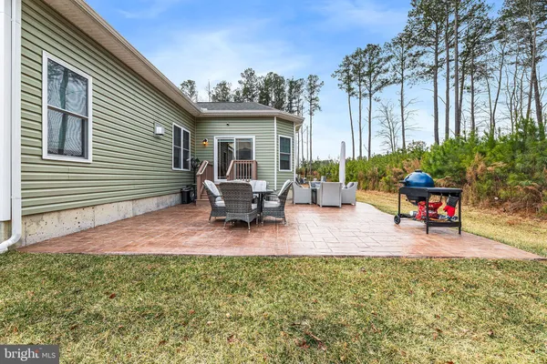 a view of a backyard with sitting area and furniture