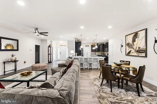 a living room with furniture a rug and white walls