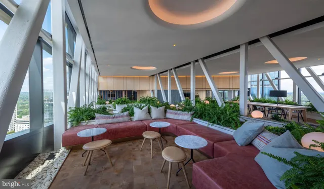 a view of a patio with couches table and chairs and potted plants
