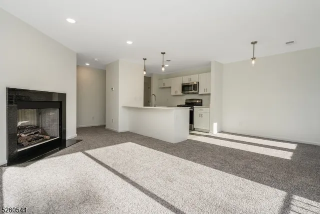 a large kitchen with a fireplace and a refrigerator