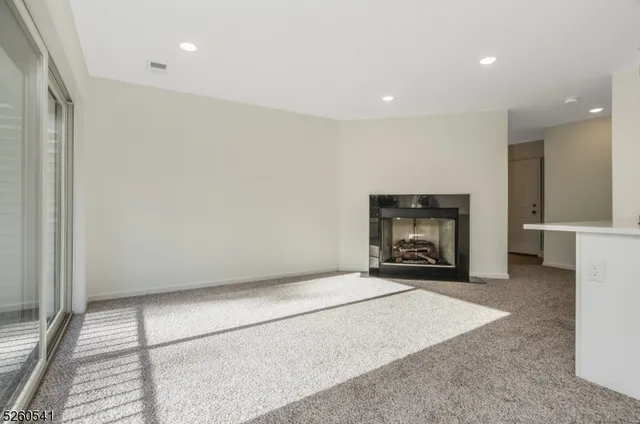a view of an empty room with a fireplace