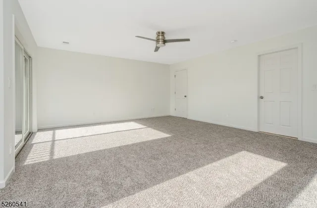 an empty room with a ceiling fan