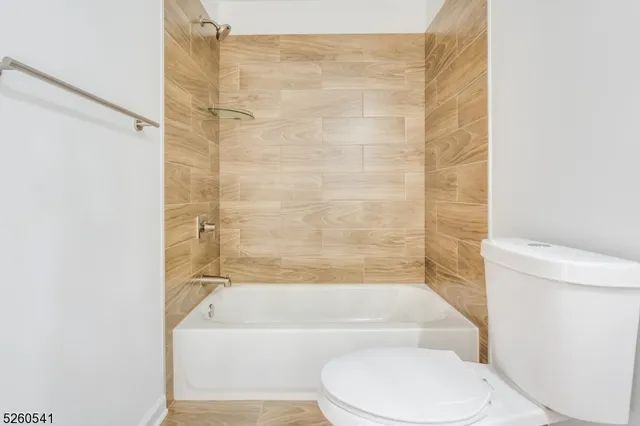 a bathroom with a toilet and a bath tub