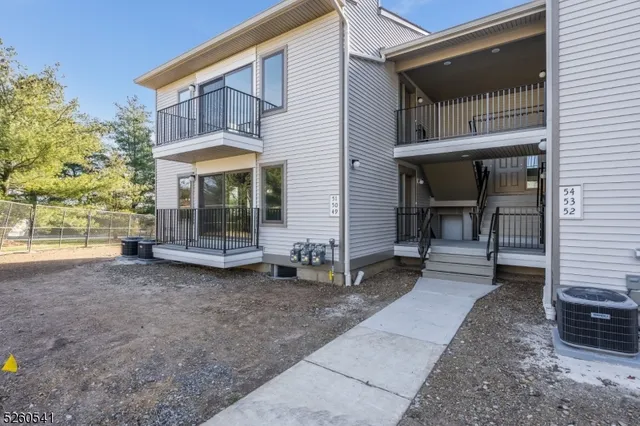 a view of a pathway with a wrought fence