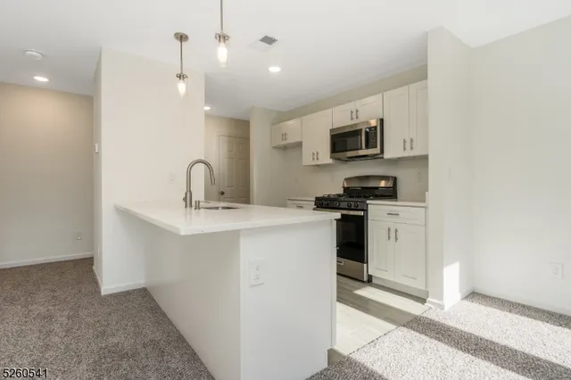 a kitchen with cabinets and stainless steel appliances