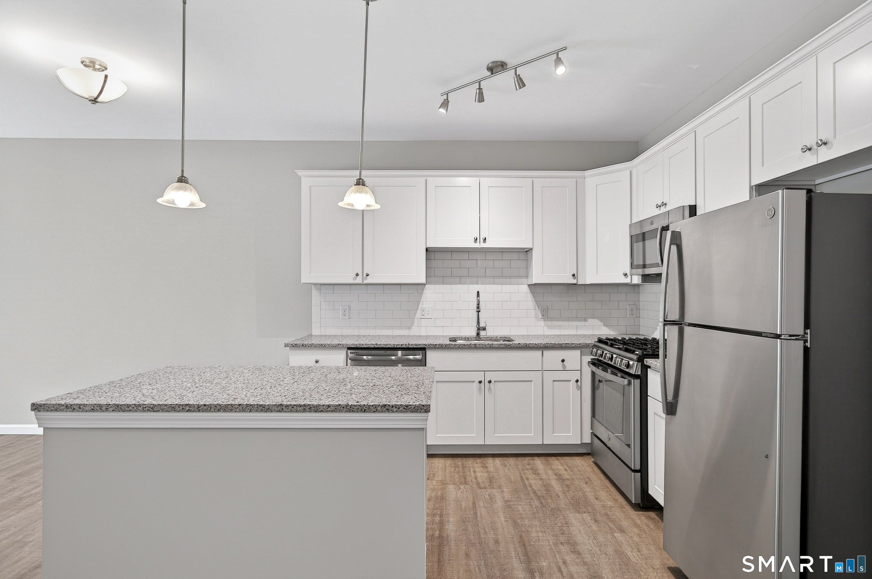 9 Covered Bridge Road Newtown, CT 06470 - Photo 6 of 27 Spacious kitchen with center island and room for a dining table.