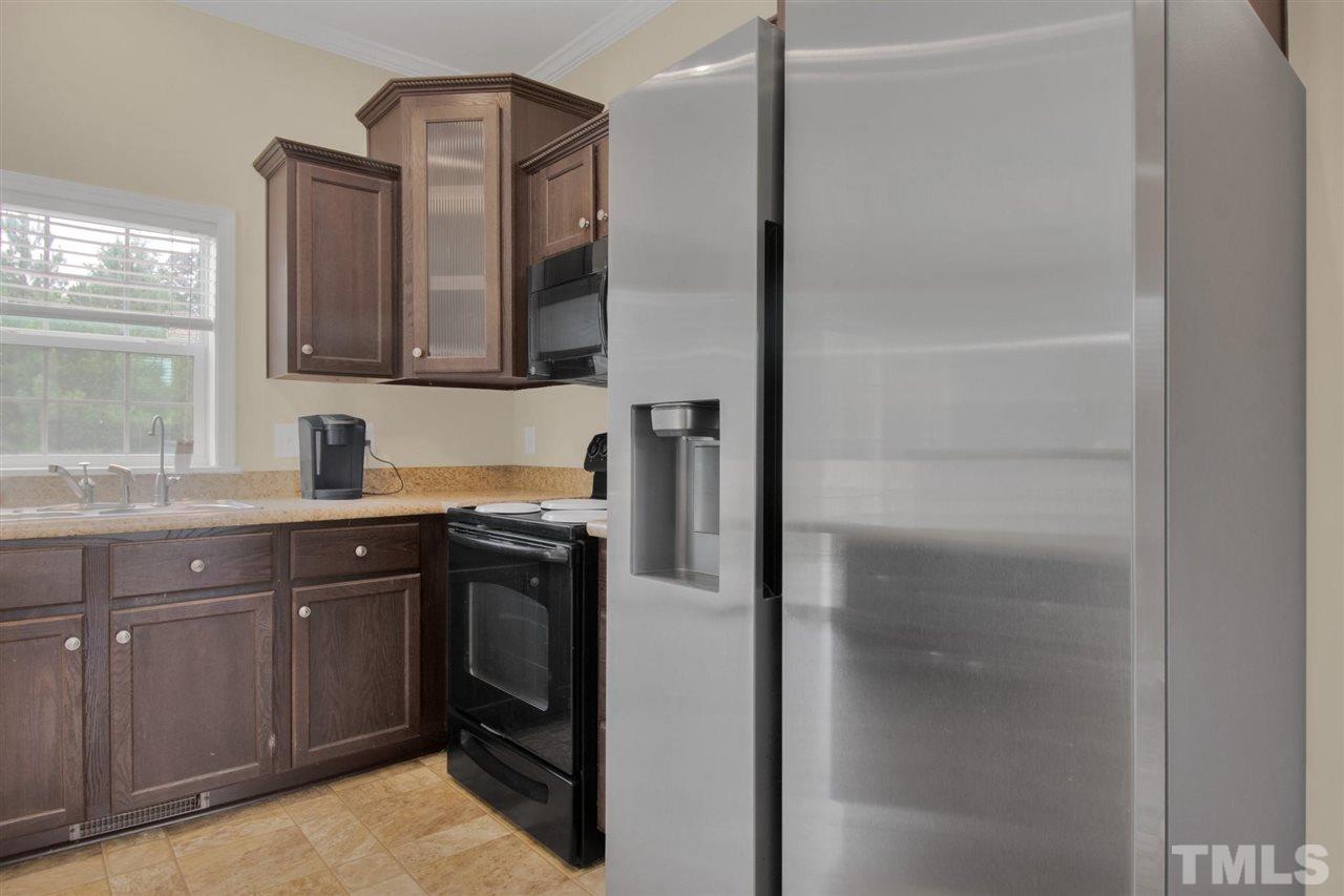 1298 L L Cooper Road Cameron, NC 28326 - Photo 12 of 30 a kitchen with a refrigerator and a sink
