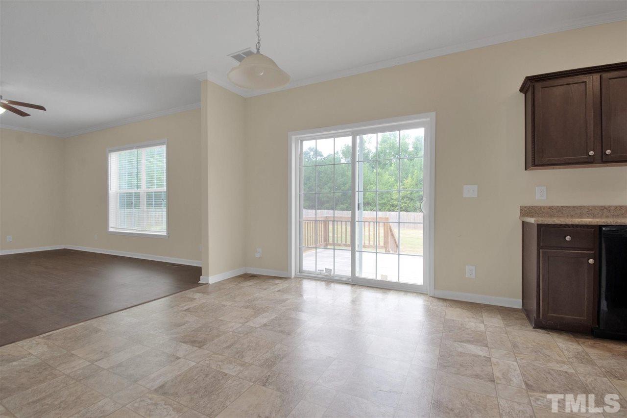 1298 L L Cooper Road Cameron, NC 28326 - Photo 14 of 30 a view of an empty room with a window and wooden floor