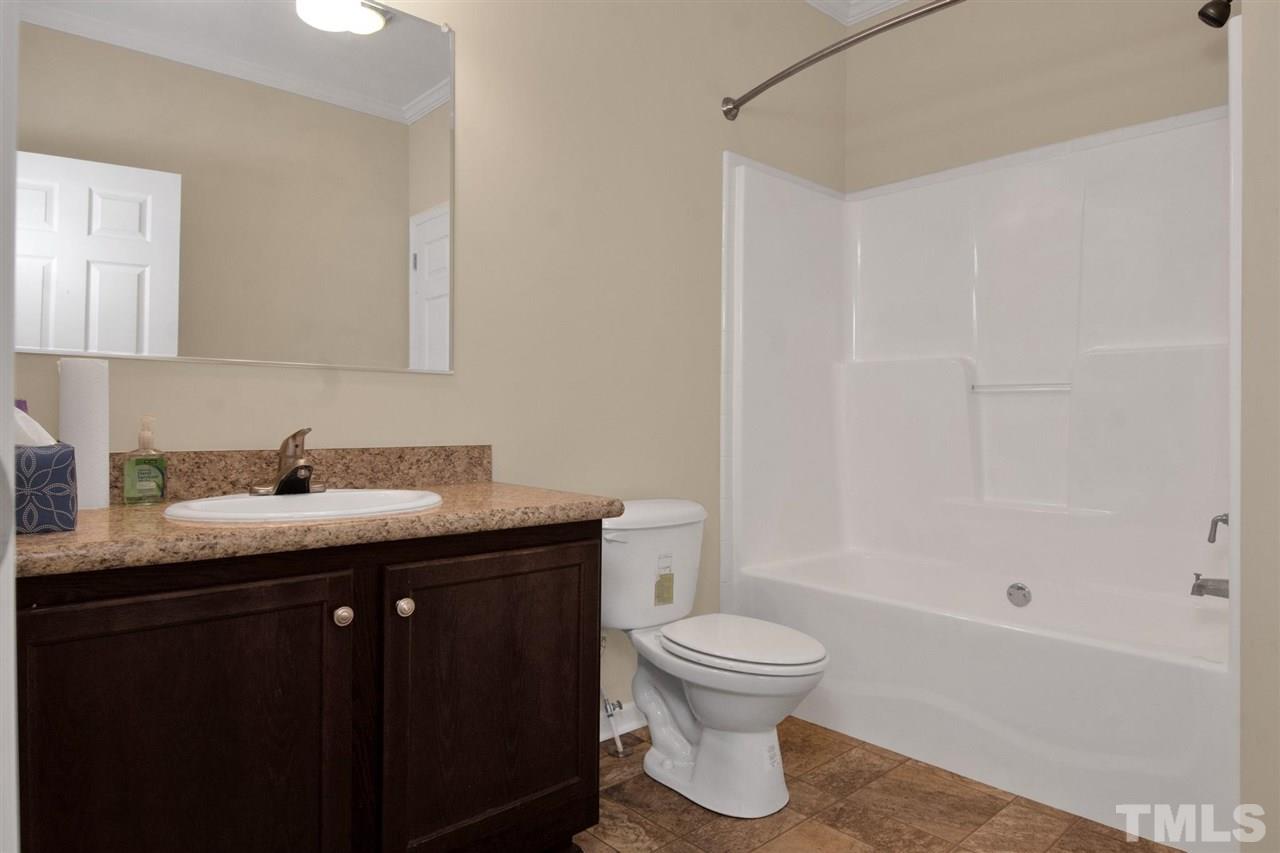 1298 L L Cooper Road Cameron, NC 28326 - Photo 24 of 30 a bathroom with a granite countertop sink toilet and shower
