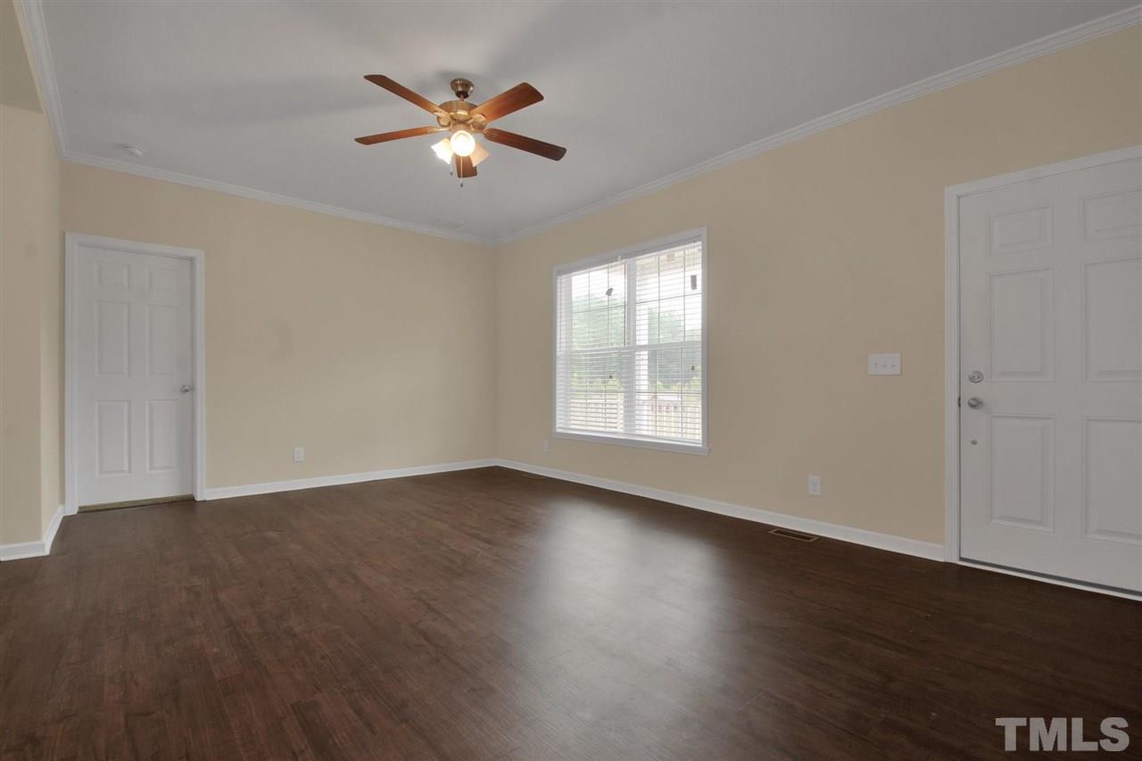 1298 L L Cooper Road Cameron, NC 28326 - Photo 4 of 30 an empty room with wooden floor and windows
