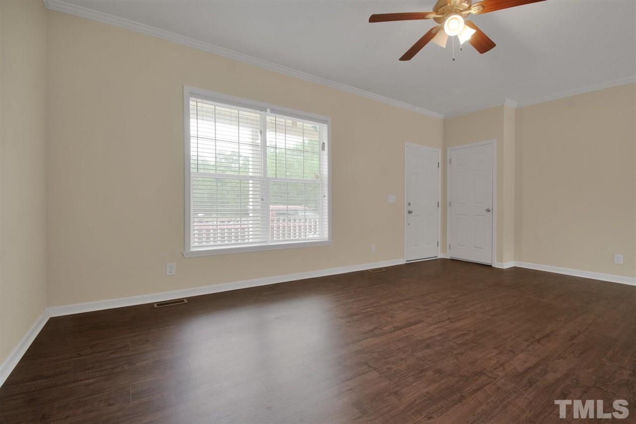 1298 L L Cooper Road Cameron, NC 28326 - Photo 5 of 30 a view of an empty room with wooden floor and a window