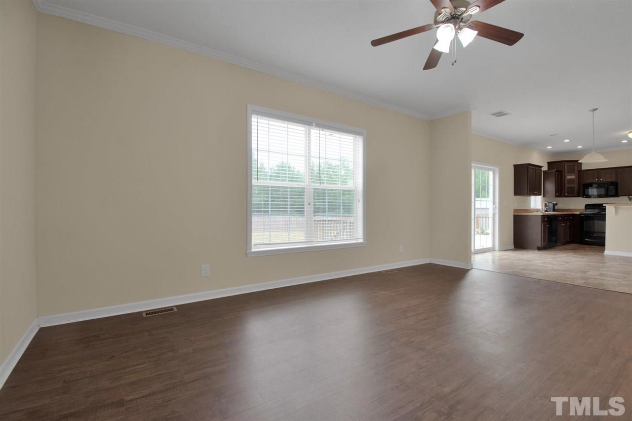 1298 L L Cooper Road Cameron, NC 28326 - Photo 8 of 30 a view of an empty room with a window and wooden floor