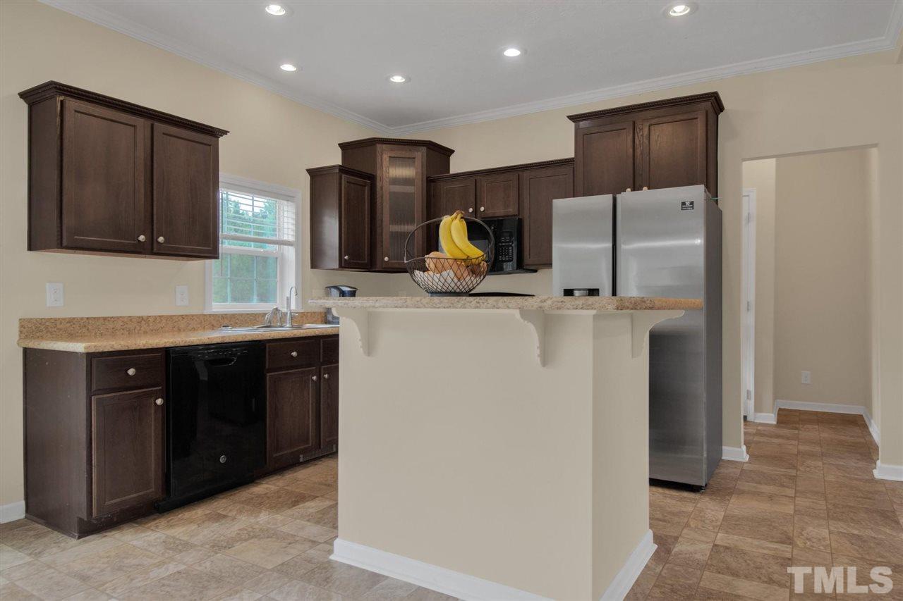 1298 L L Cooper Road Cameron, NC 28326 - Photo 9 of 30 a kitchen with stainless steel appliances a refrigerator and a sink