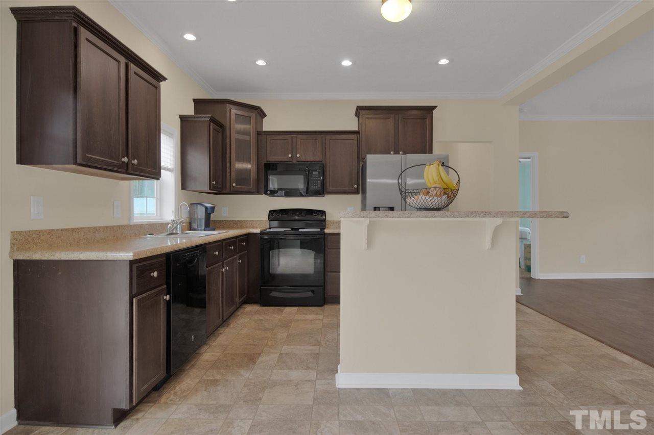 1298 L L Cooper Road Cameron, NC 28326 - Photo 10 of 30 a kitchen with stainless steel appliances granite countertop a refrigerator stove microwave and sink