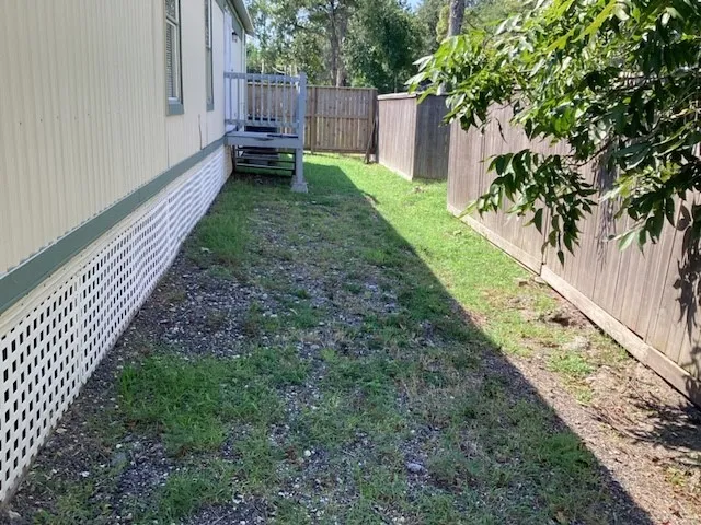 a view of a backyard with wooden fence