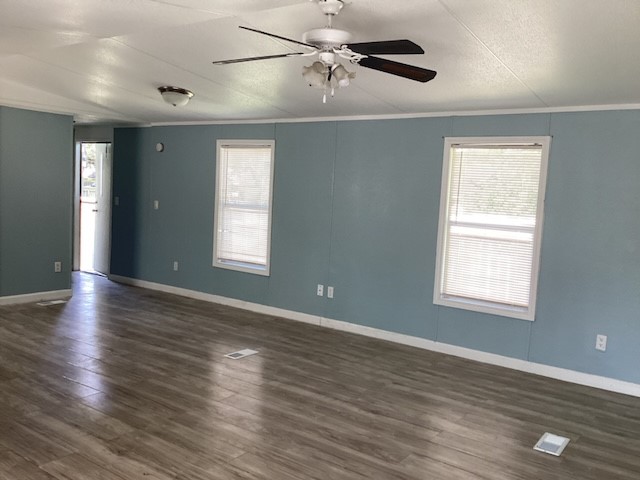 306 West Wallisville Road Highlands, TX 77562 - Photo 6 of 14 a view of an empty room with wooden floor and a window