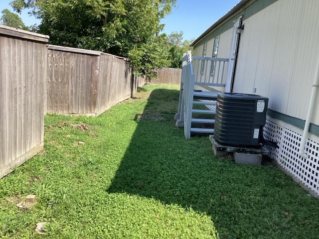306 West Wallisville Road Highlands, TX 77562 - Photo 9 of 14 a view of a backyard with wooden fence