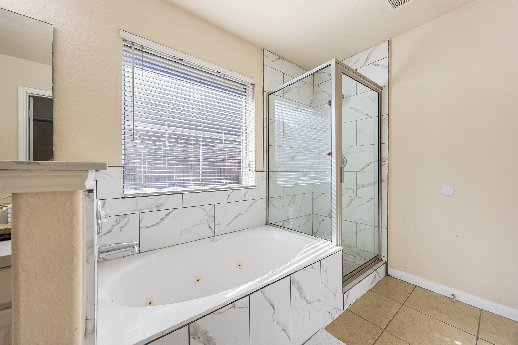 18739 Appletree Ridge Road Houston, TX 77084 - Photo 18 of 34 a bathroom with a bathtub and a shower