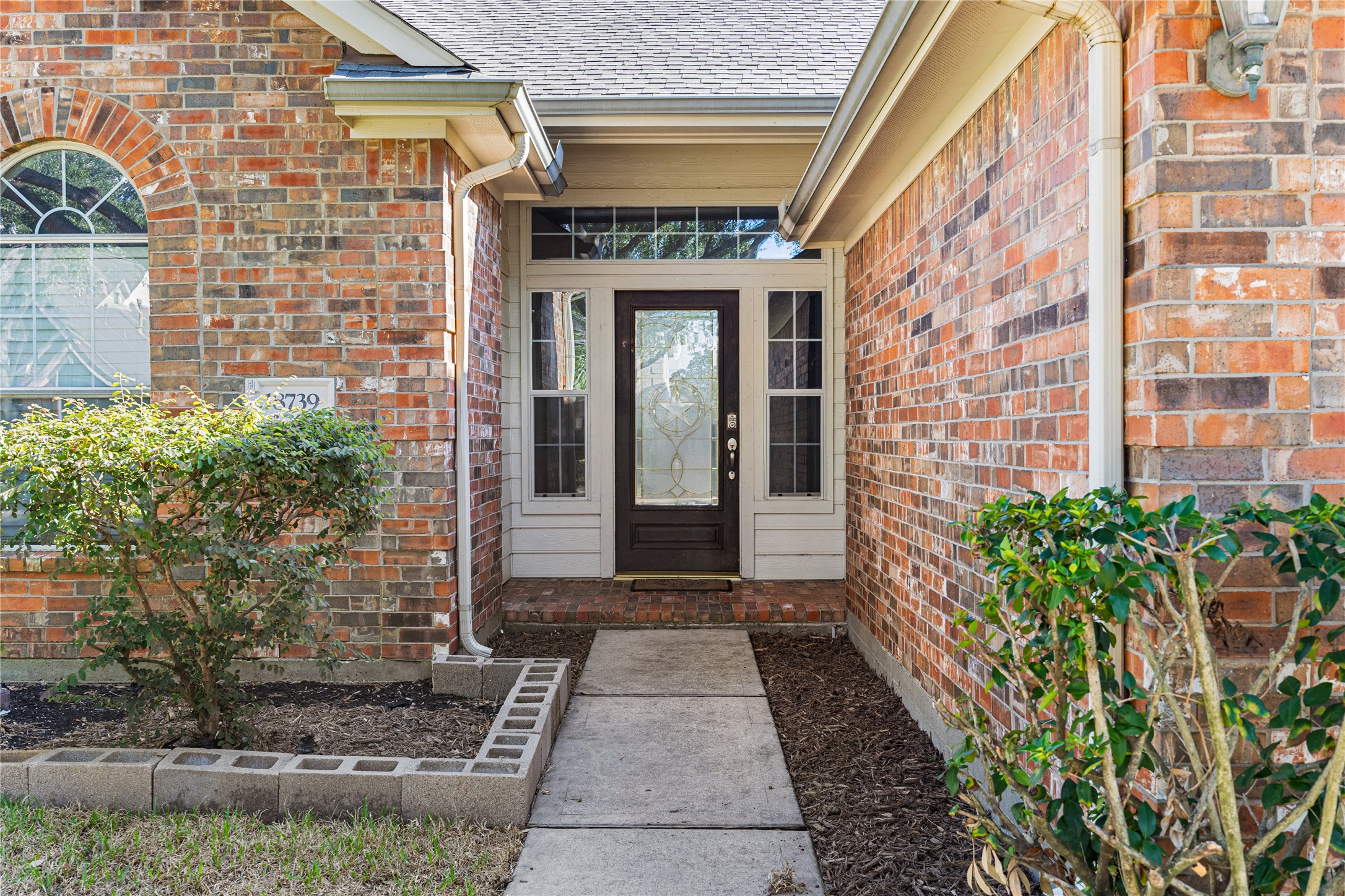 18739 Appletree Ridge Road Houston, TX 77084 - Photo 2 of 34 a front view of a brick house with a large windows