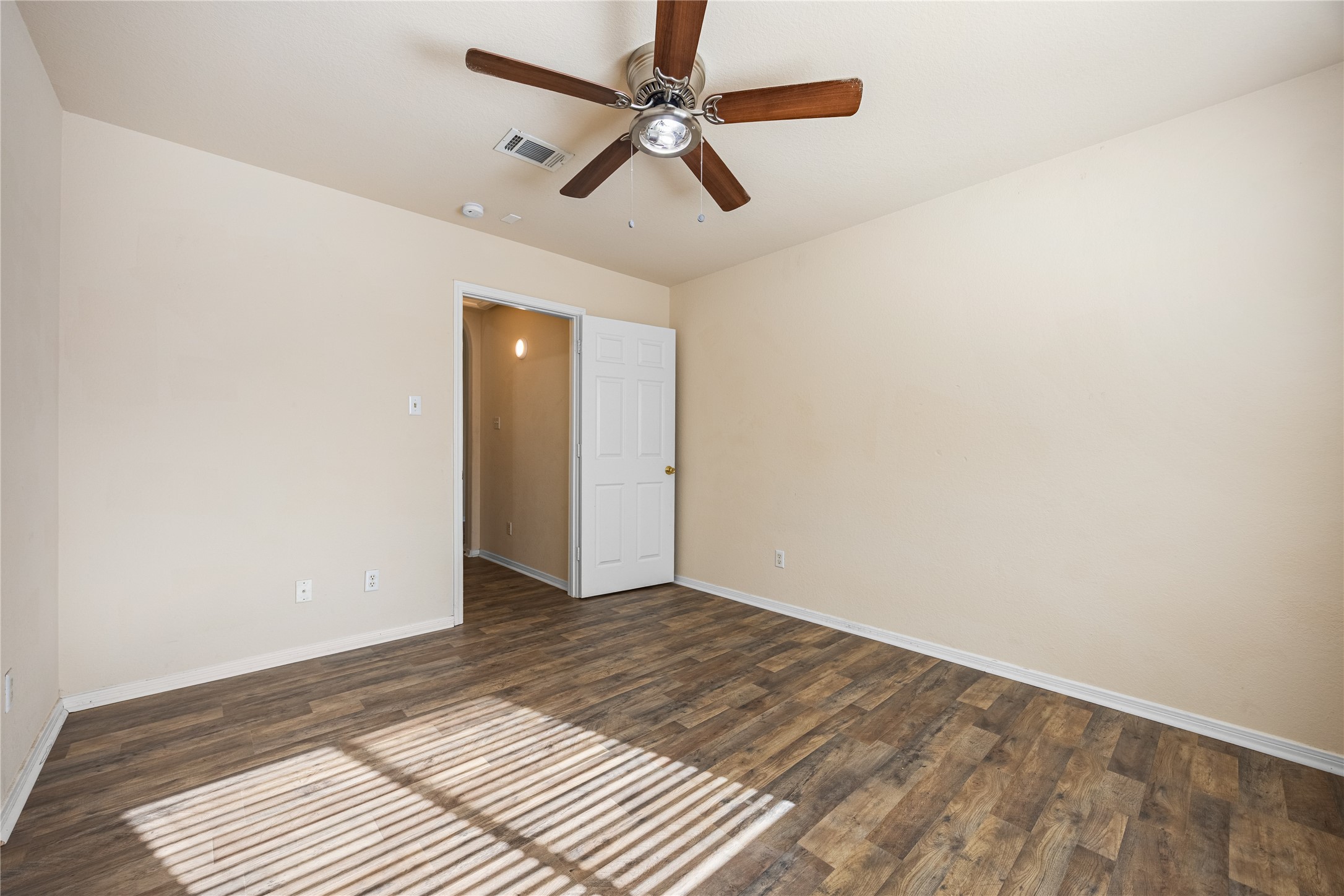 18739 Appletree Ridge Road Houston, TX 77084 - Photo 21 of 34 a view of a room with wooden floor and a ceiling fan