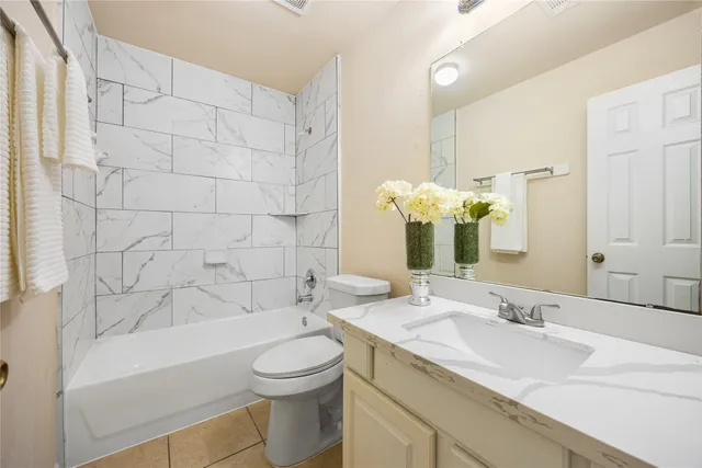 a view of a room with wooden floor and a ceiling fan