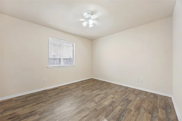 a view of a room with an empty space and a ceiling fan