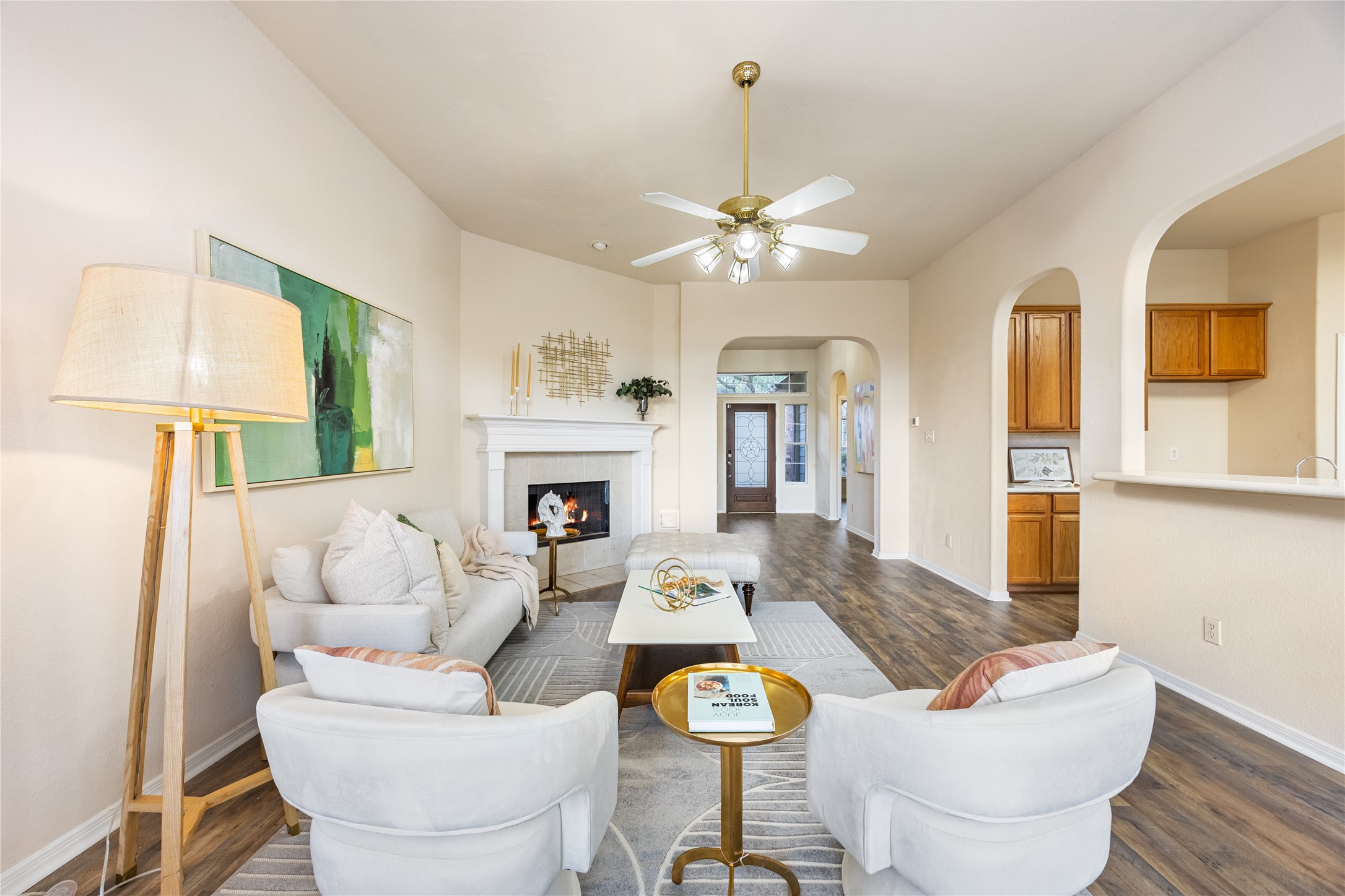 18739 Appletree Ridge Road Houston, TX 77084 - Photo 7 of 34 a living room with furniture a fireplace and a chandelier