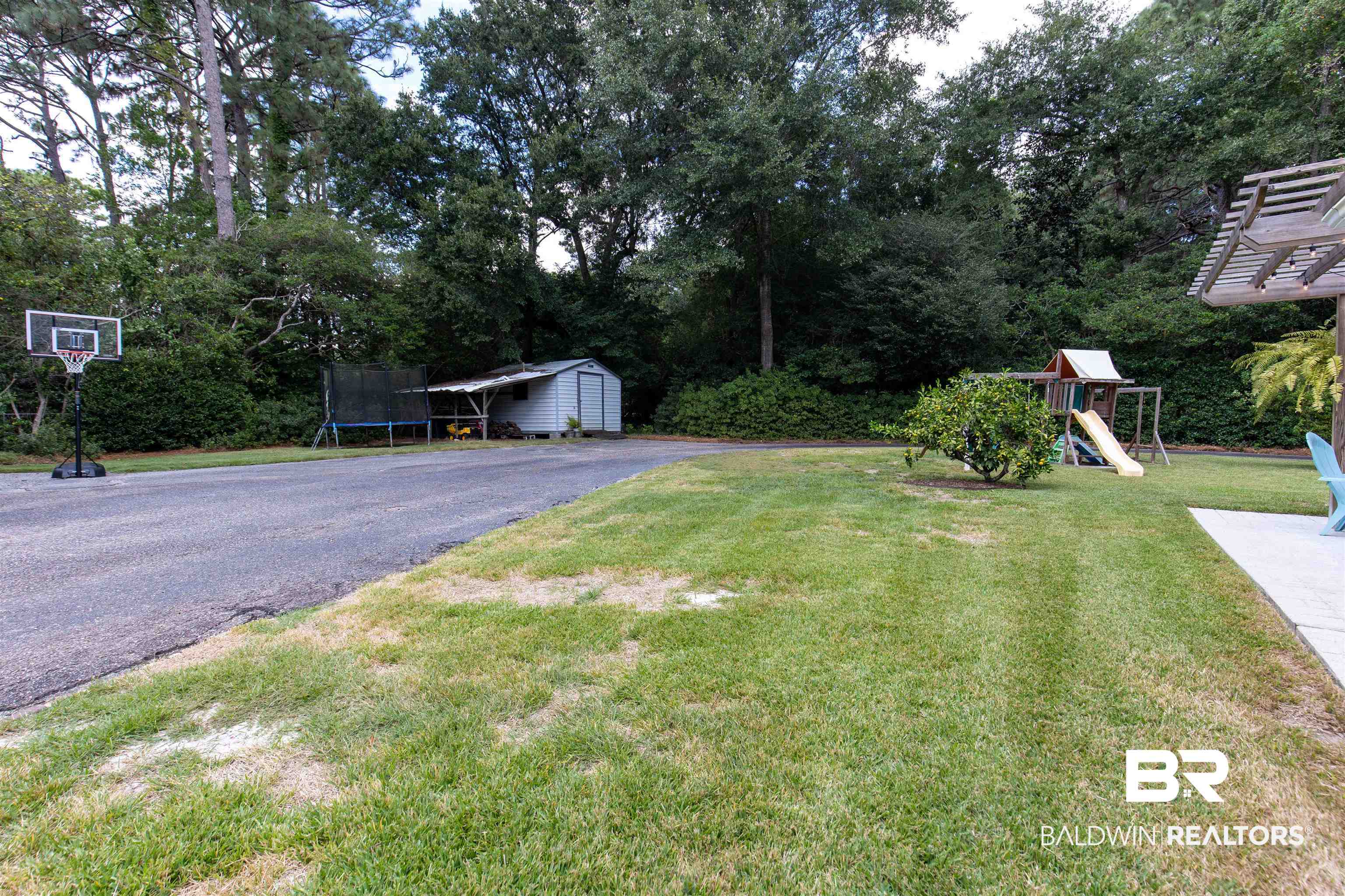 4306 Michael Boulevard Mobile, AL 36609 - Photo 28 of 35 View of yard featuring a playground, a shed with attached lean-to