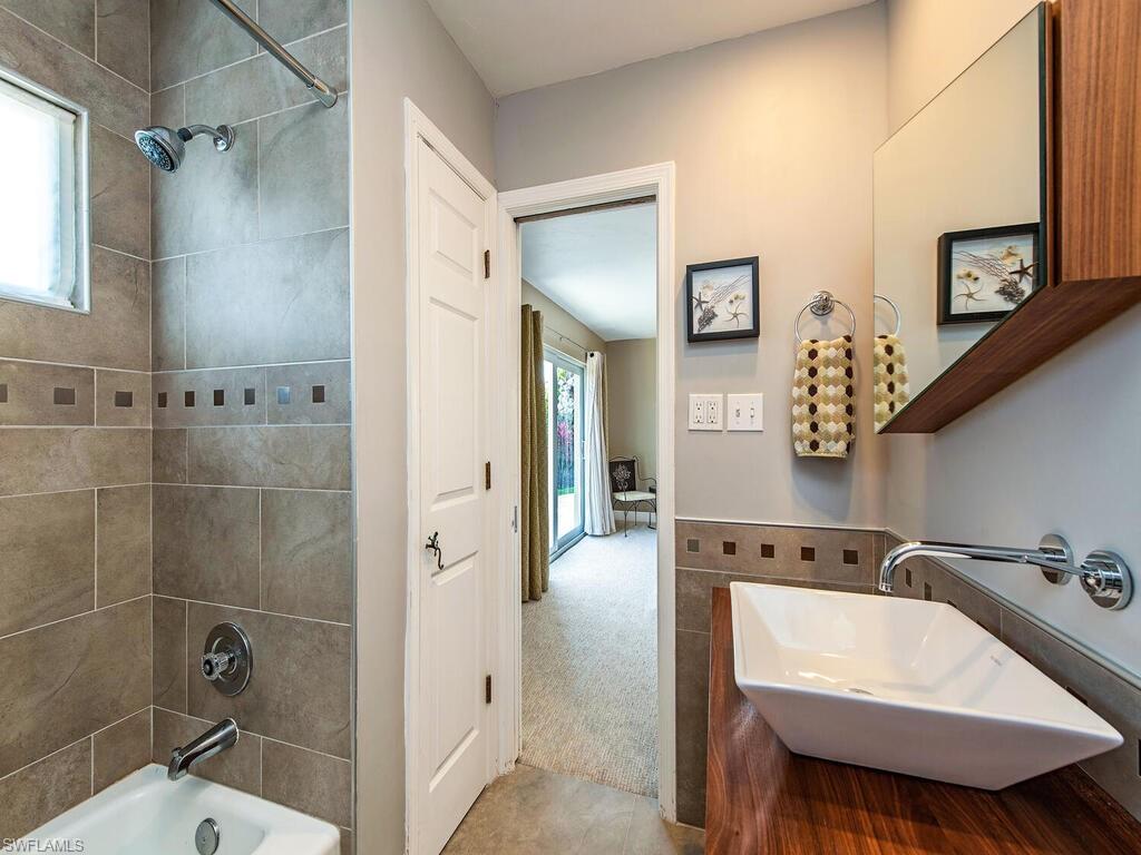 540 Rudder Road Naples, FL 34102 - Photo 11 of 12 a bathroom with a sink a toilet and shower