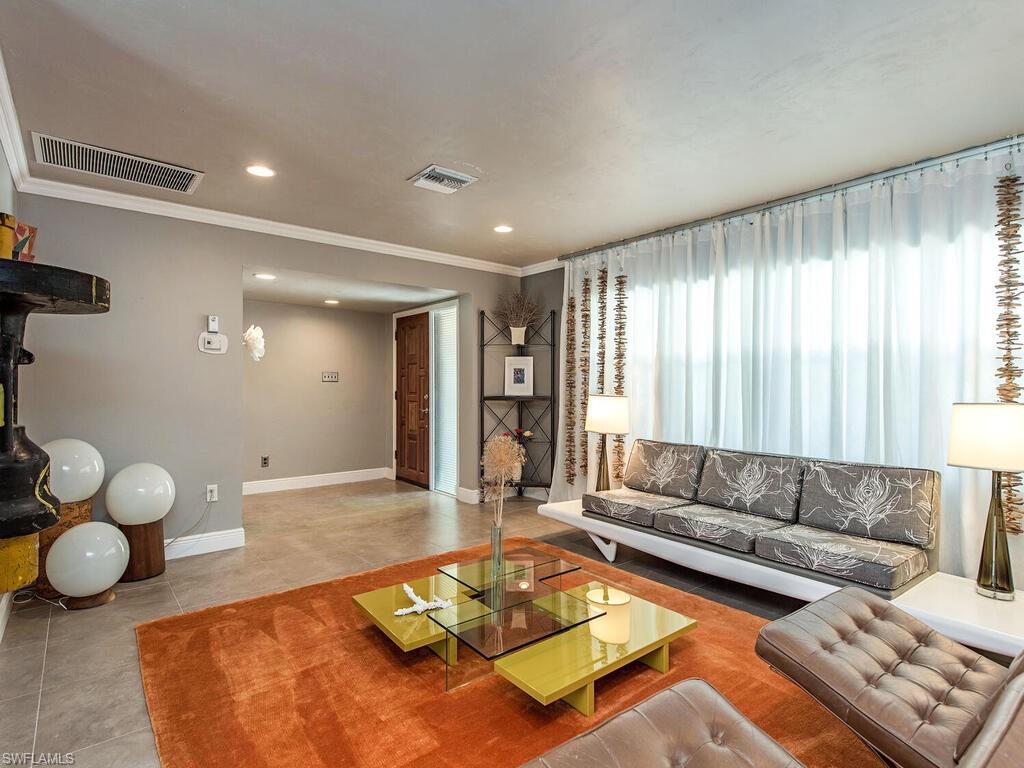 540 Rudder Road Naples, FL 34102 - Photo 2 of 12 a living room with furniture and a large window