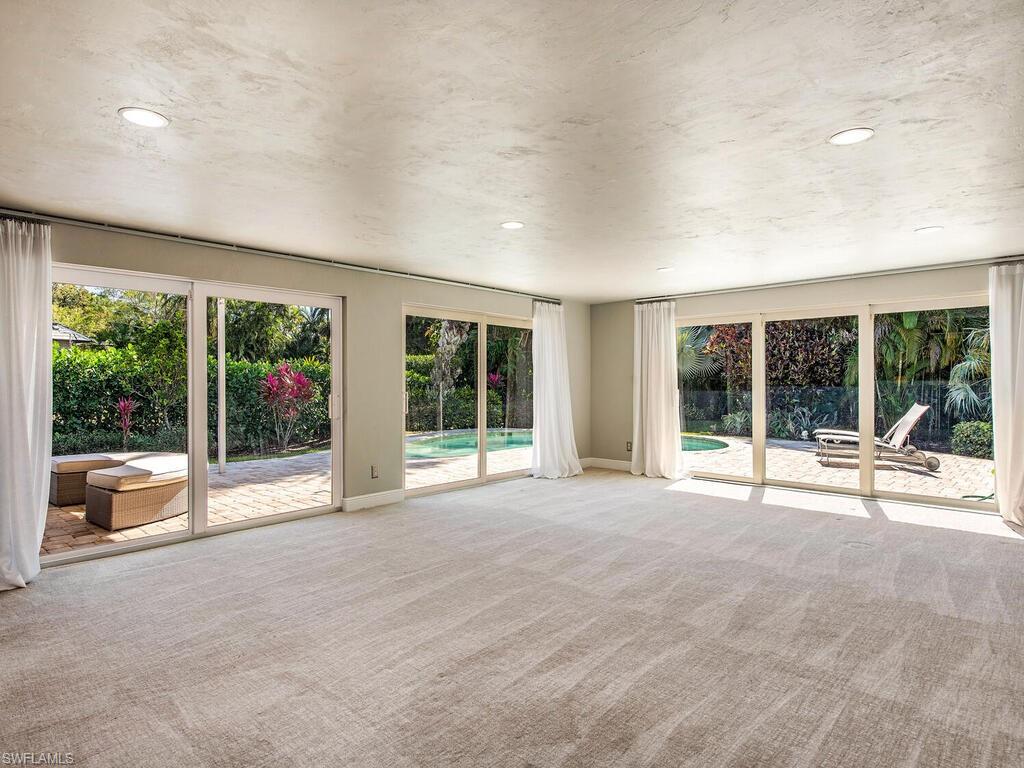 540 Rudder Road Naples, FL 34102 - Photo 5 of 12 a living room with furniture and large windows