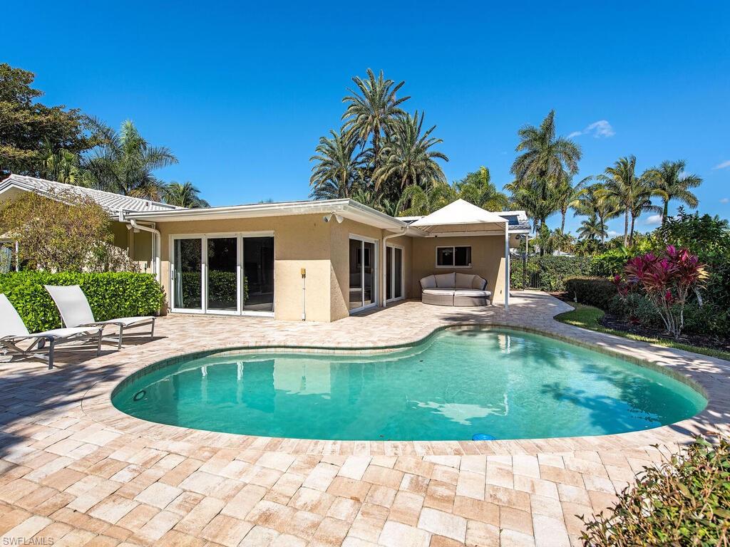 540 Rudder Road Naples, FL 34102 - Photo 6 of 12 a view of house that has a yard