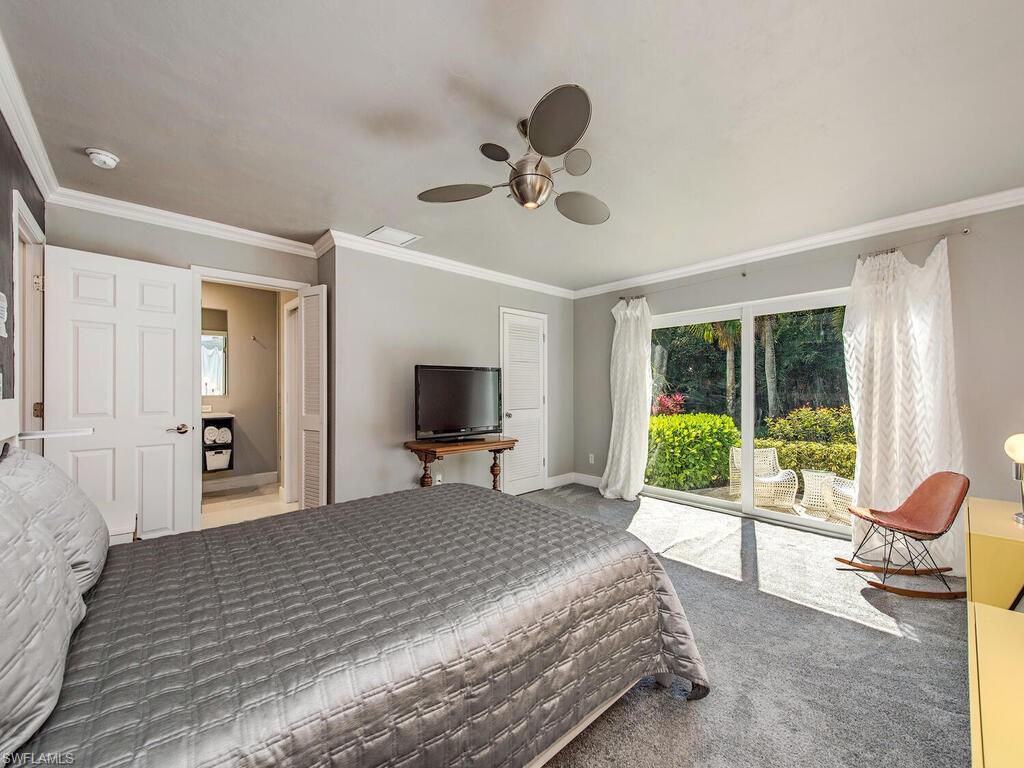 540 Rudder Road Naples, FL 34102 - Photo 8 of 12 a bedroom with a bed and a large window