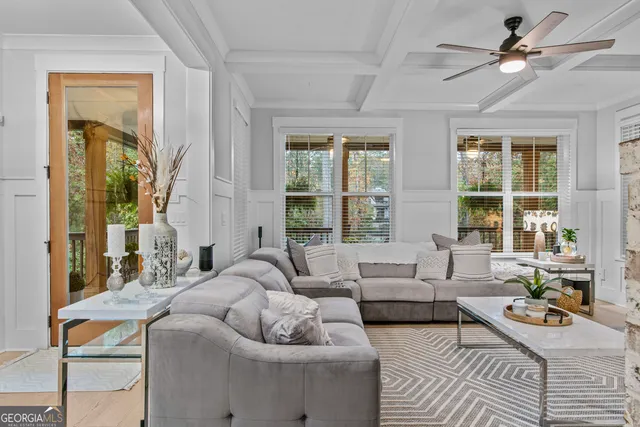 a view of a dining room with furniture a chandelier and wooden floor