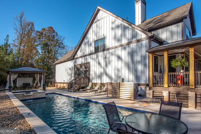 a kitchen with stainless steel appliances kitchen island granite countertop a stove top oven a sink and a refrigerator