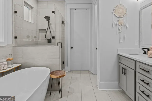 a bedroom with a bed a chair and a chandelier