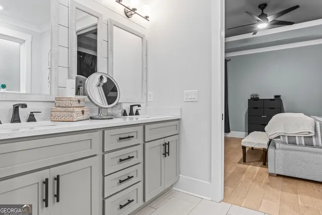 a bathroom with a granite countertop sink a toilet and shower