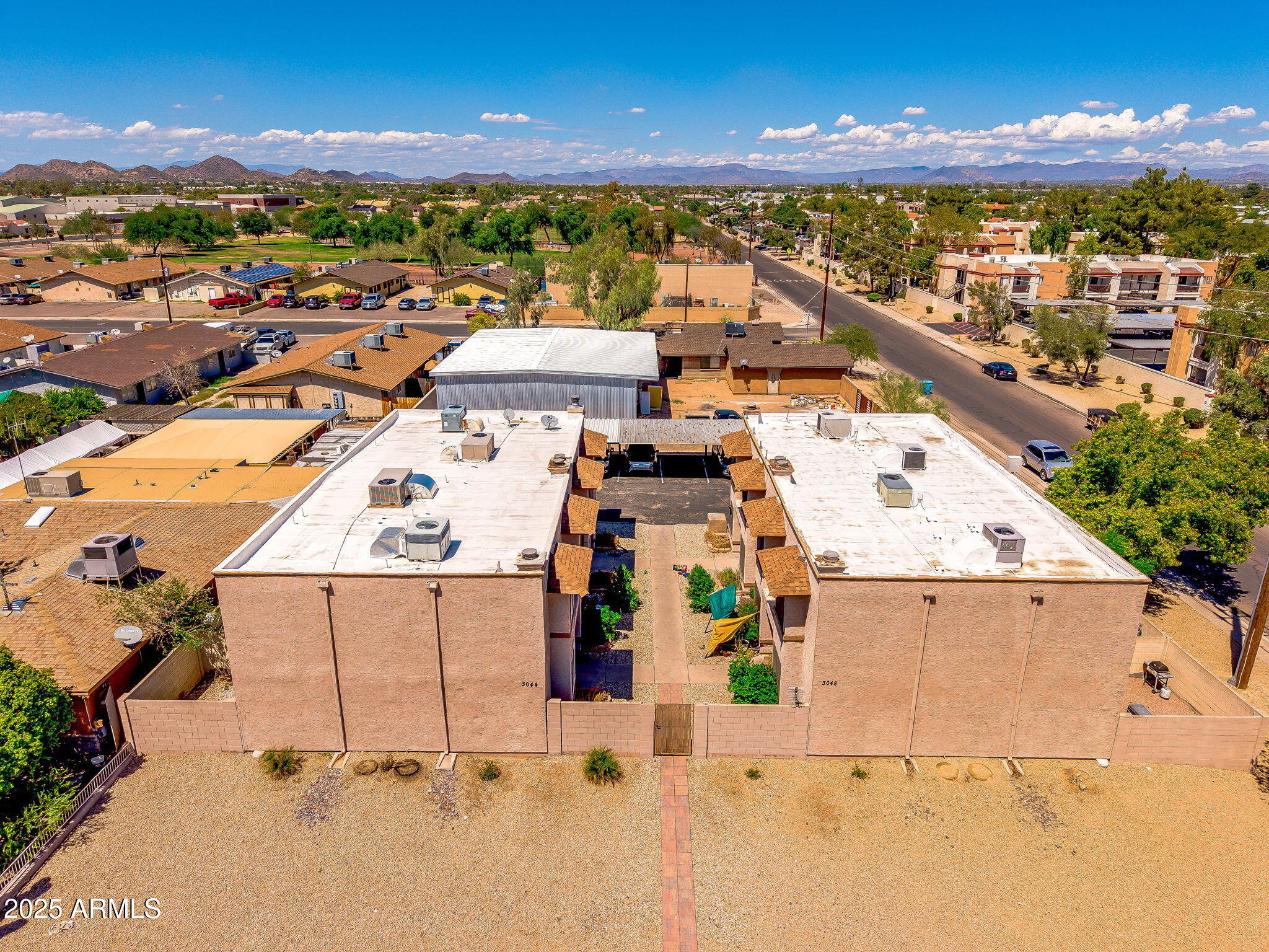 3048 East Beck Lane Phoenix, AZ 85032 - Photo 3 of 13 an aerial view of residential houses with outdoor space